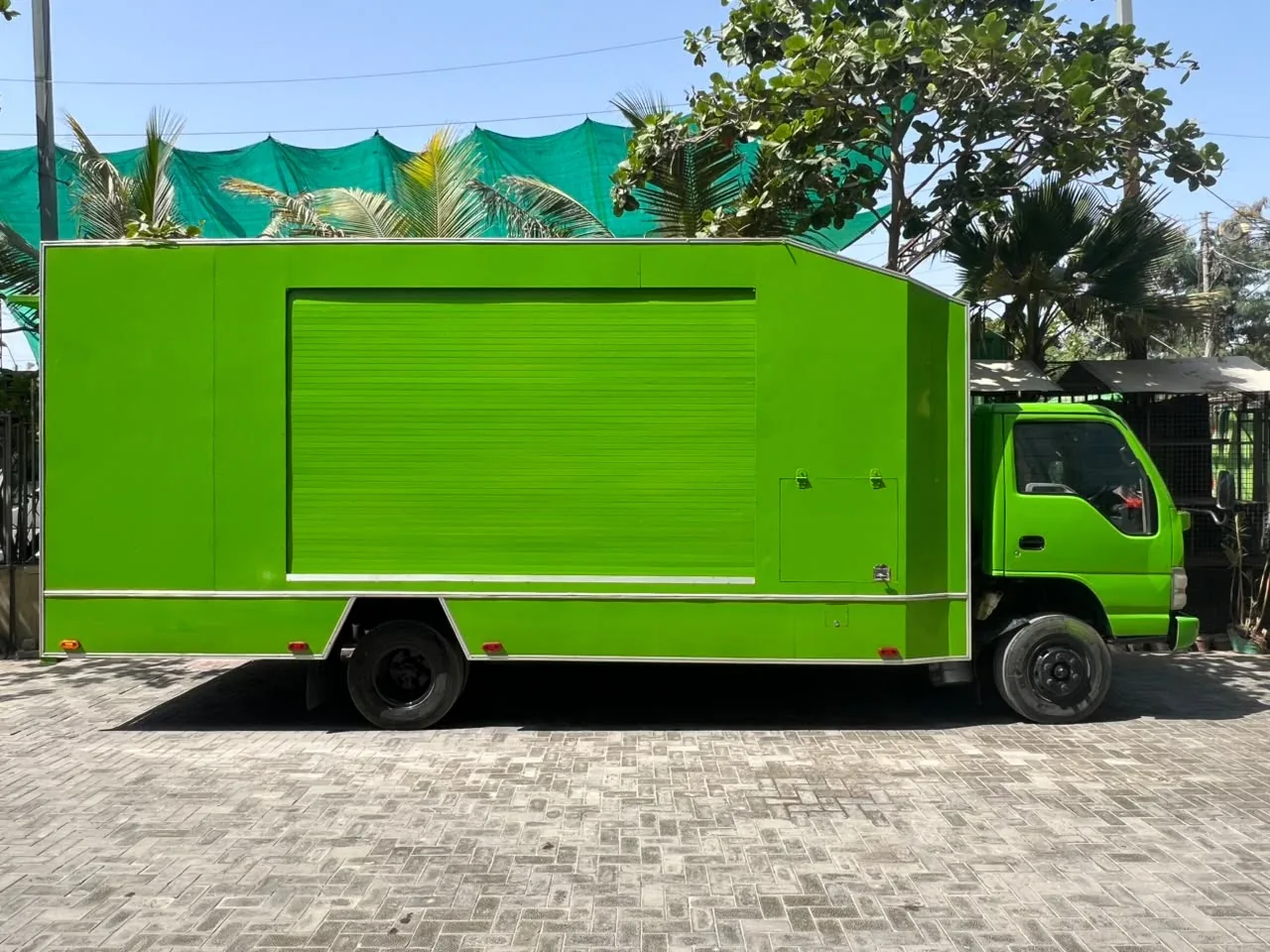 Side view of PTN’s lime-green enclosed vehicle carrier
